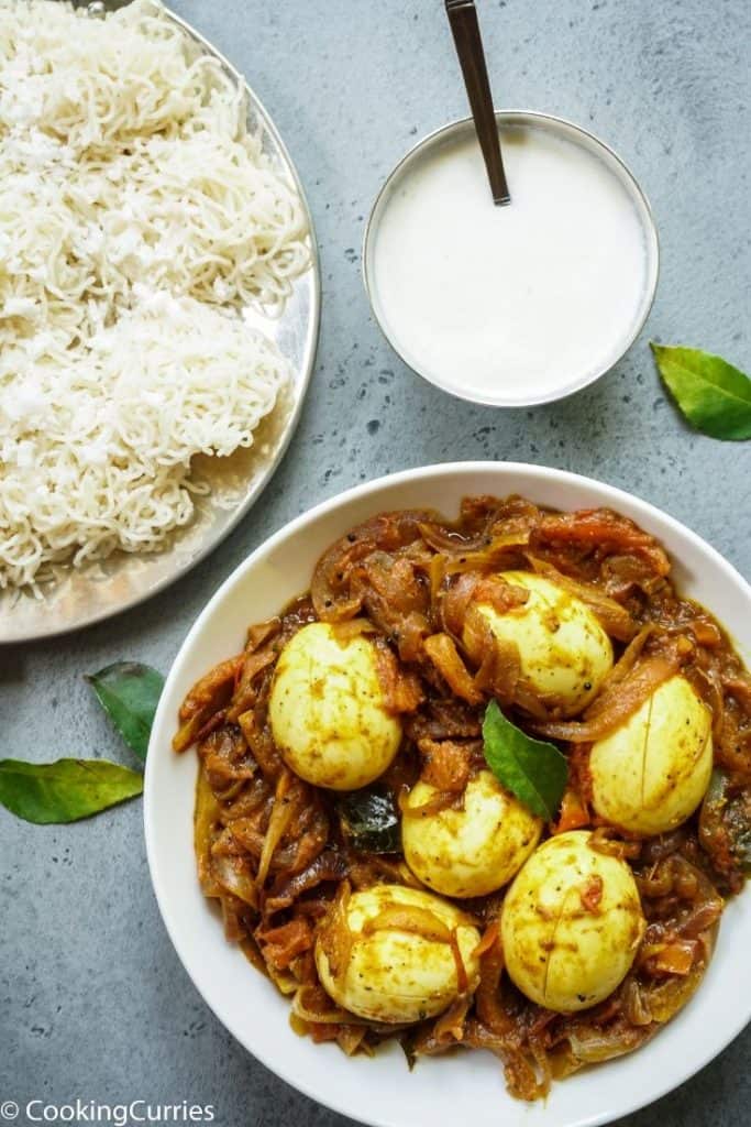 Indian breakfast set up of boiled eggs, rice noodles and coconut milk