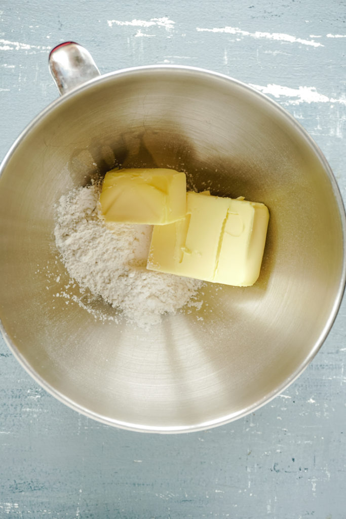 Top shot of butter and powdered sugar in a mixing bowl