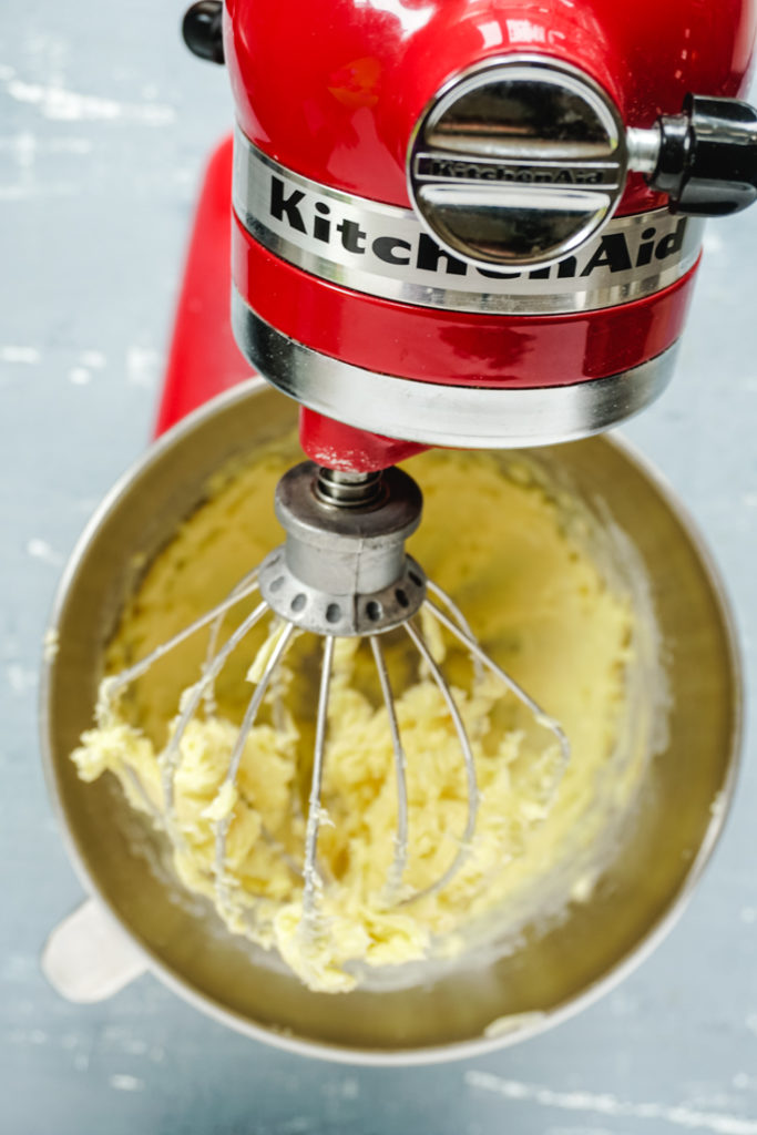 Top shot of stand mixer with whipped butter and sugar in the mixing bowl
