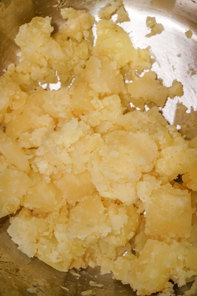 In process shot of crumbled potatoes
