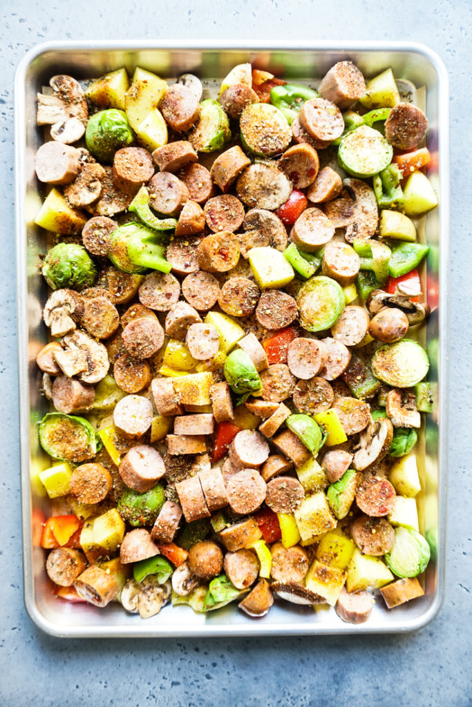 Sasage and vegetables in a sheet pan ready to go in to the oven