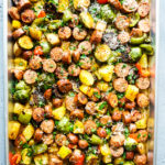 Cooked sausage and vegetables in a sheet pan