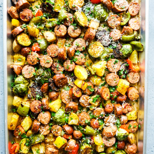 Cooked sausage and vegetables in a sheet pan