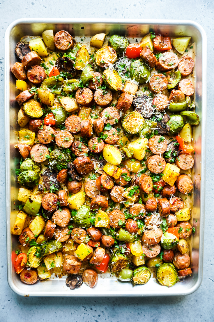 Cooked sausage and vegetables in a sheet pan