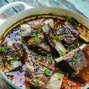 Angle shot of short ribs curry in a white dutch oven