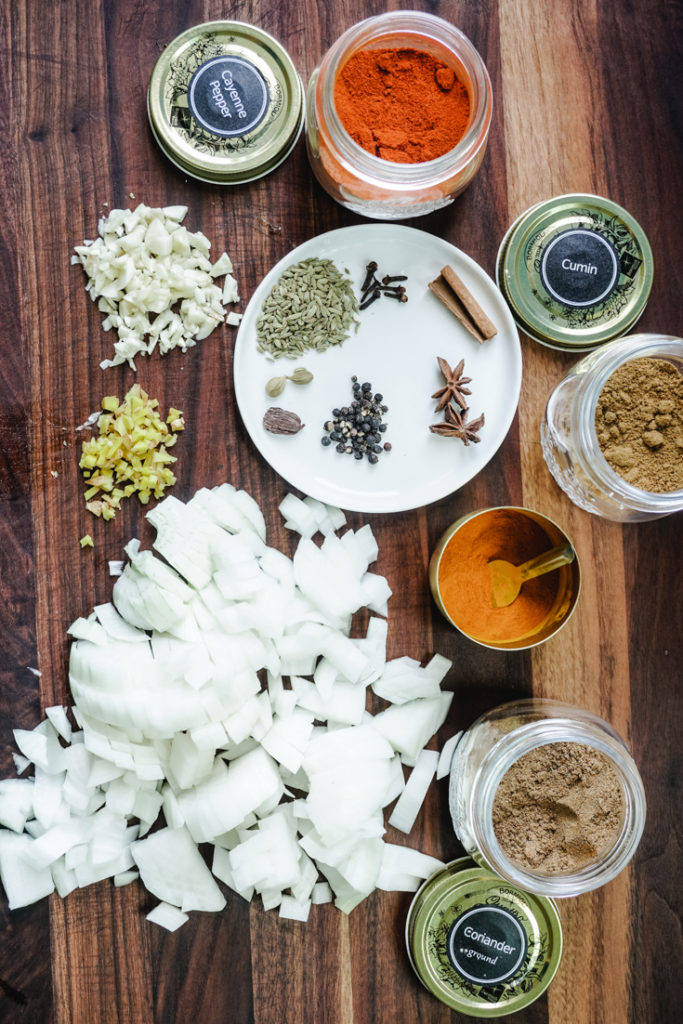Ingredients for the short ribs curry laid out on a wooden board