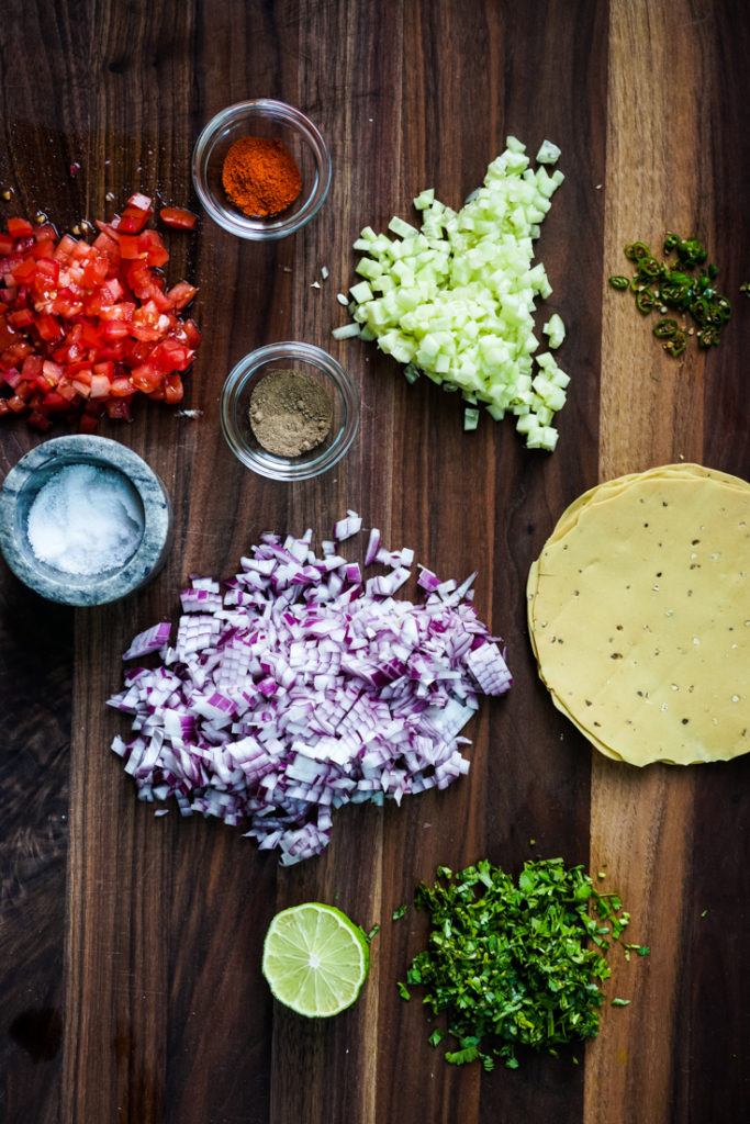 Ingredients for Masala papad placed on a wood board