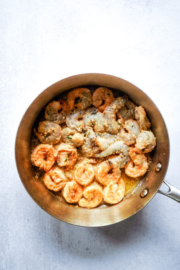 Part of the shrimp in the pan flipped over after cooking to show how it should look