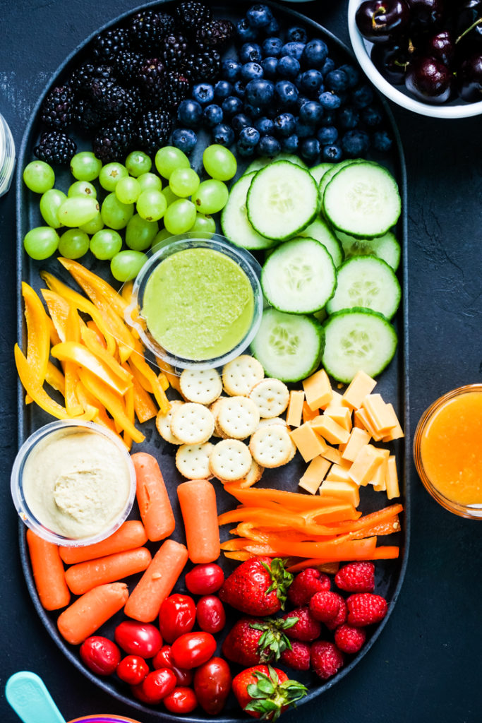 Top shot of a snack platter with rainbow colored snacks in it