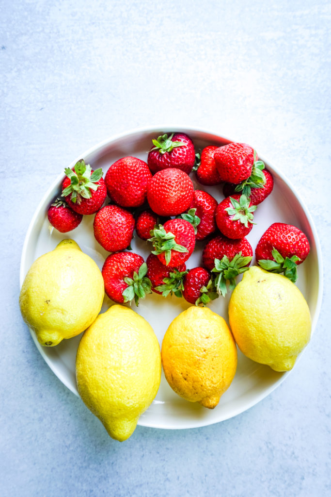Strawberries and lemon in a white plate