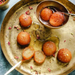 platter with gulab jamun and a bowl with gulab jamun