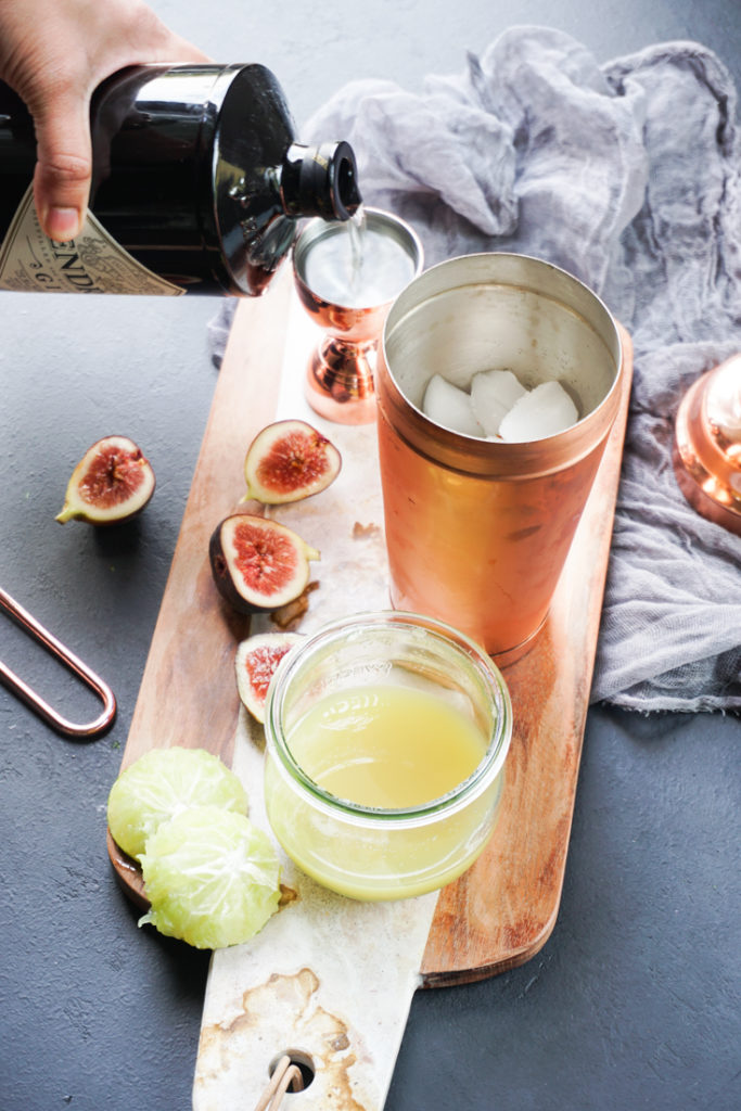 Hendricks gin being poured into a copper jigger