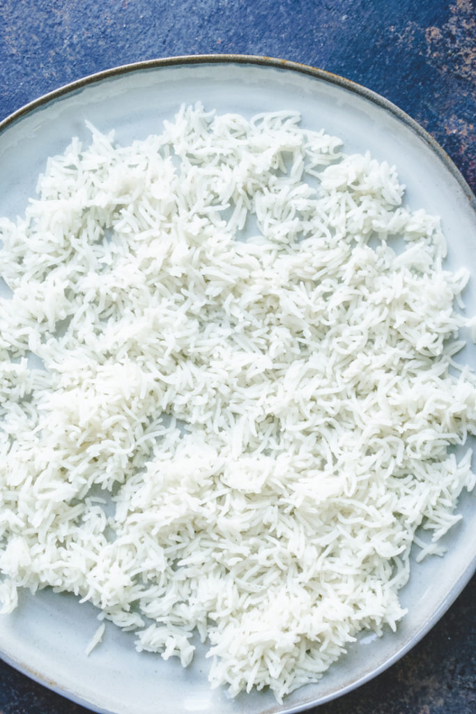 Cooked basmati rice spread out on a plate