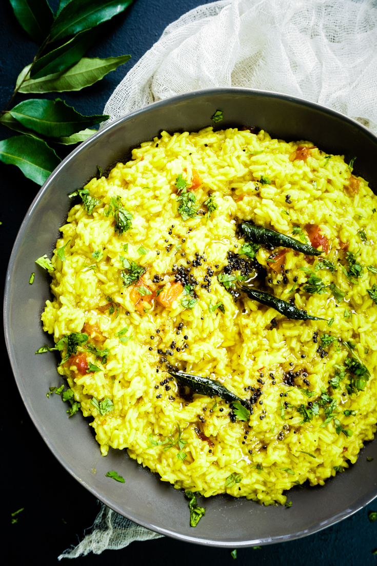 close up shot of grey bowl with rasam rice in it