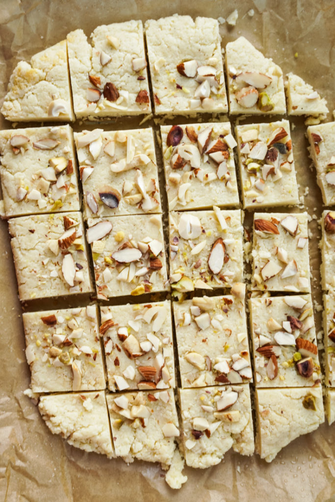 burfi on parchment paper cut into squares