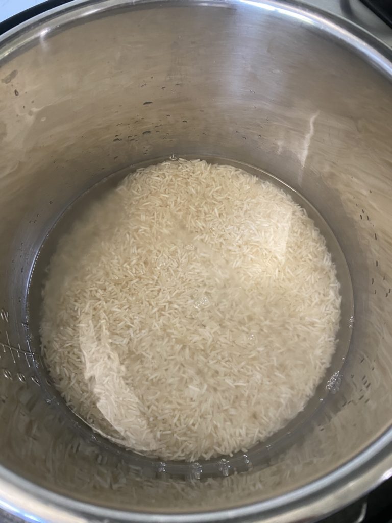Raw basmati rice covered with water in the Instant Pot