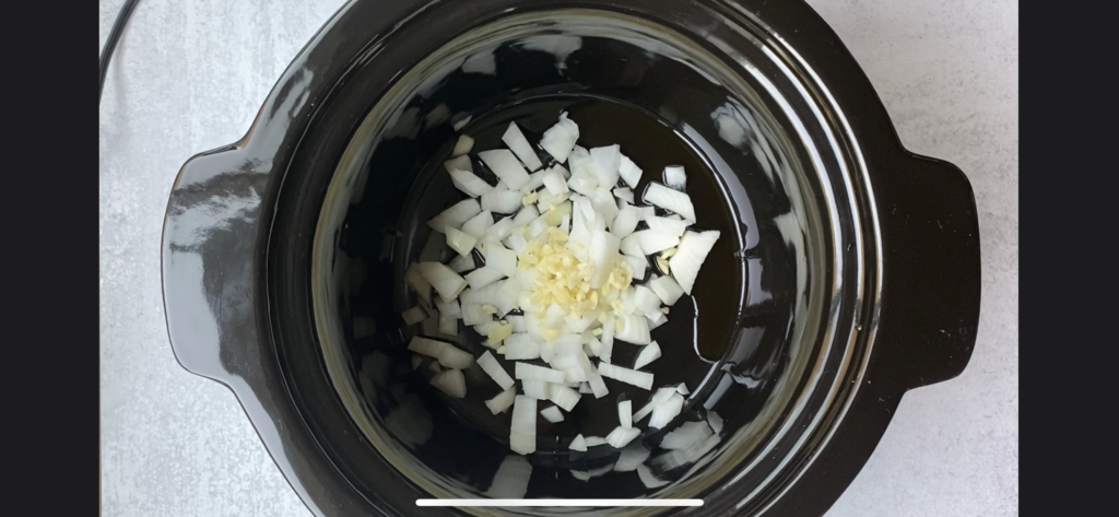 chopped onion and garlic in a crockpot