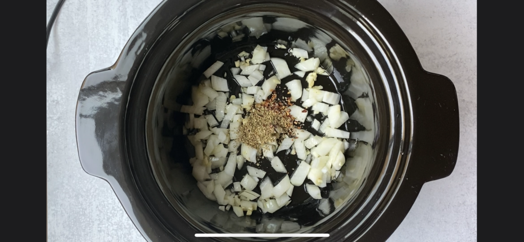 onions and dried herbs in the crockpot