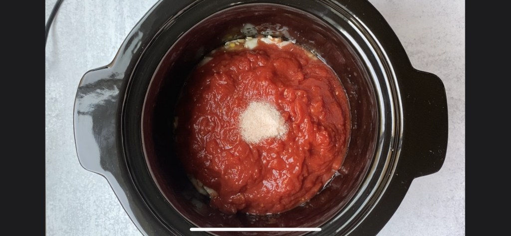 crushed tomatoes topped with salt in the crockpot