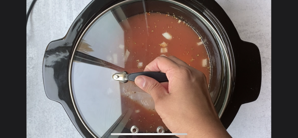 hand closing the crockpot with a lid