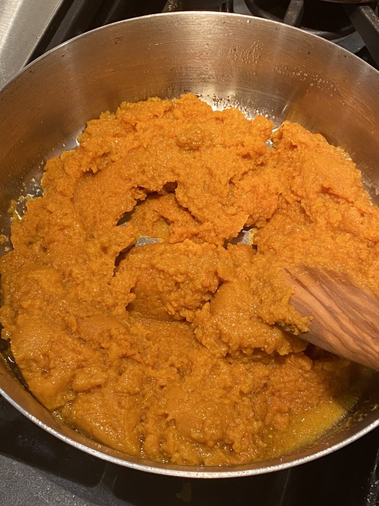 Pumpkin puree sauteeing in ghee in a pan