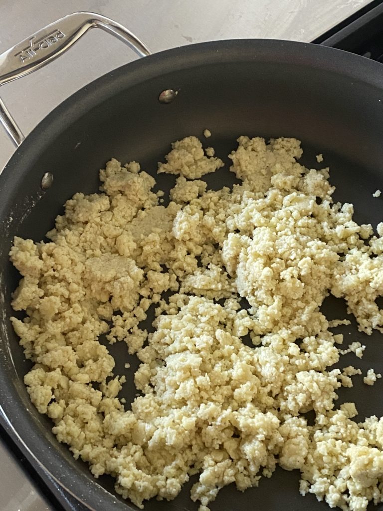 crumbly mixture of milk powder and sugar in a pan