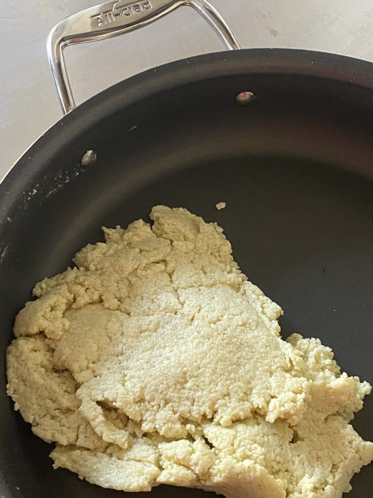 doughy mixture of milk powder and sugar in a pan