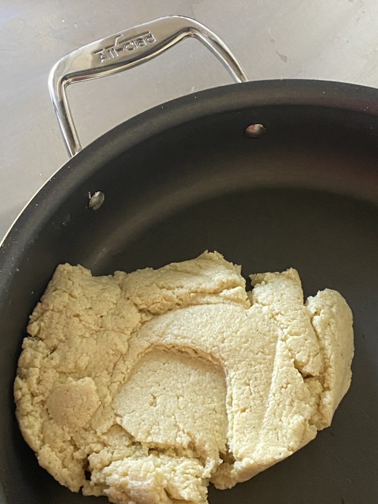 doughy mixture of milk powder and sugar in a pan