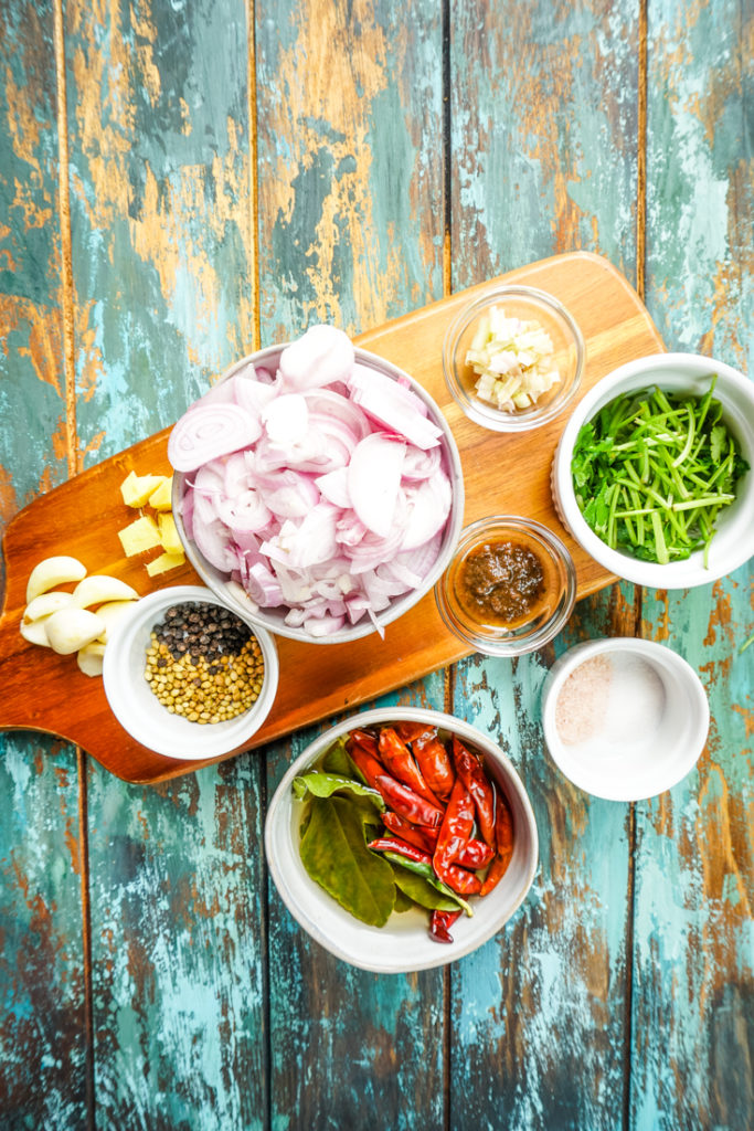 Ingredients for Thai red curry paste laid out in bowls