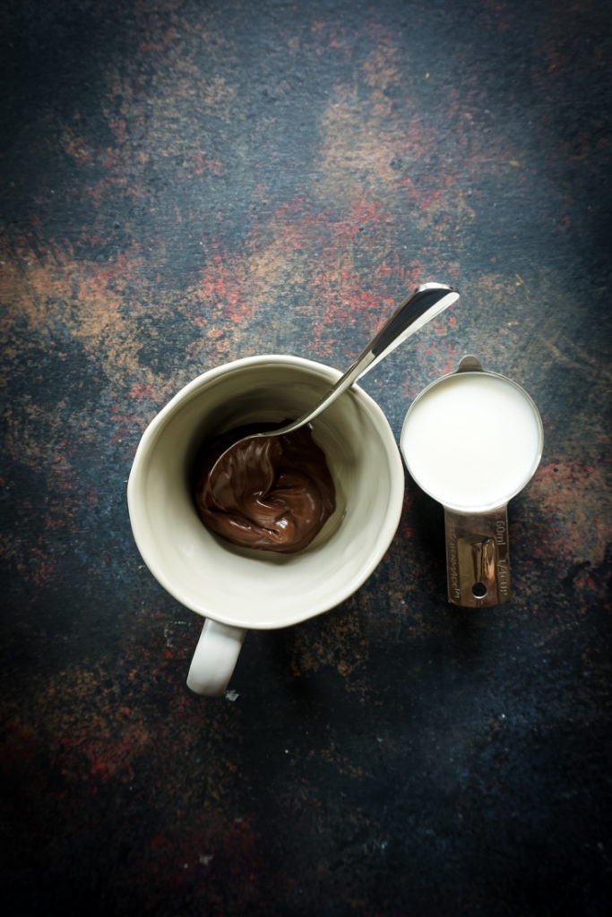 mug with nutella and a spoon in it
