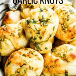 garlic knots in a basket with text overlay on image
