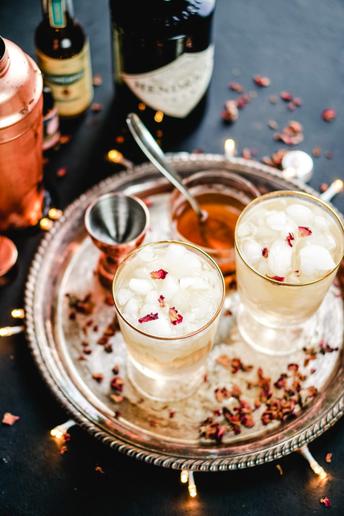 cardamom rose cocktail in two gold rimmed glasses on a silver platter