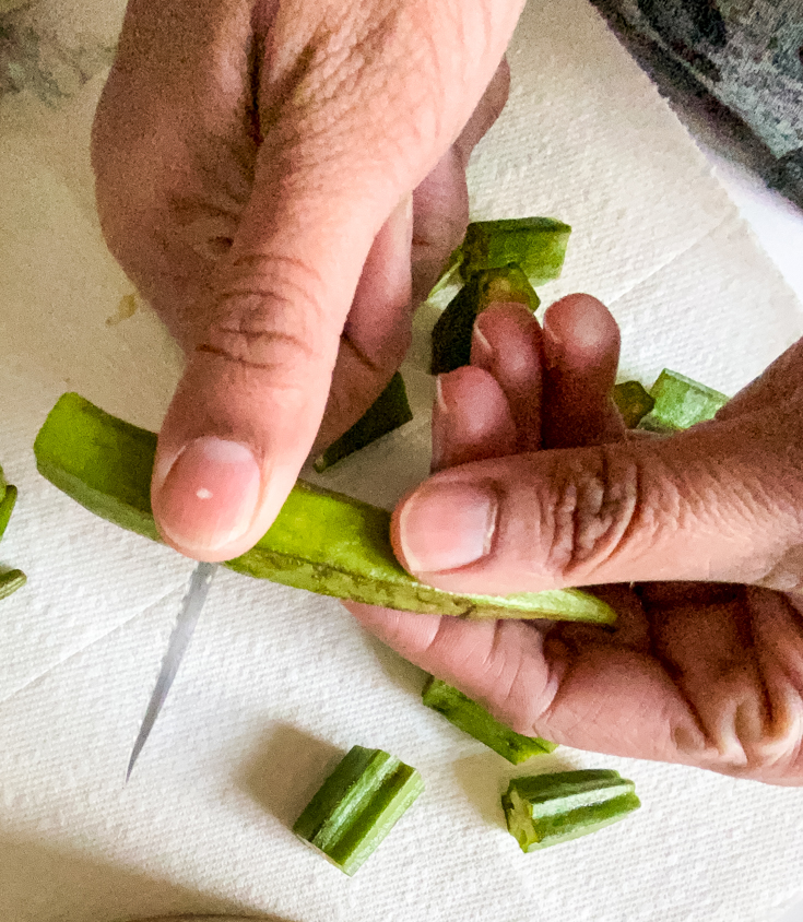 hands cutting okra