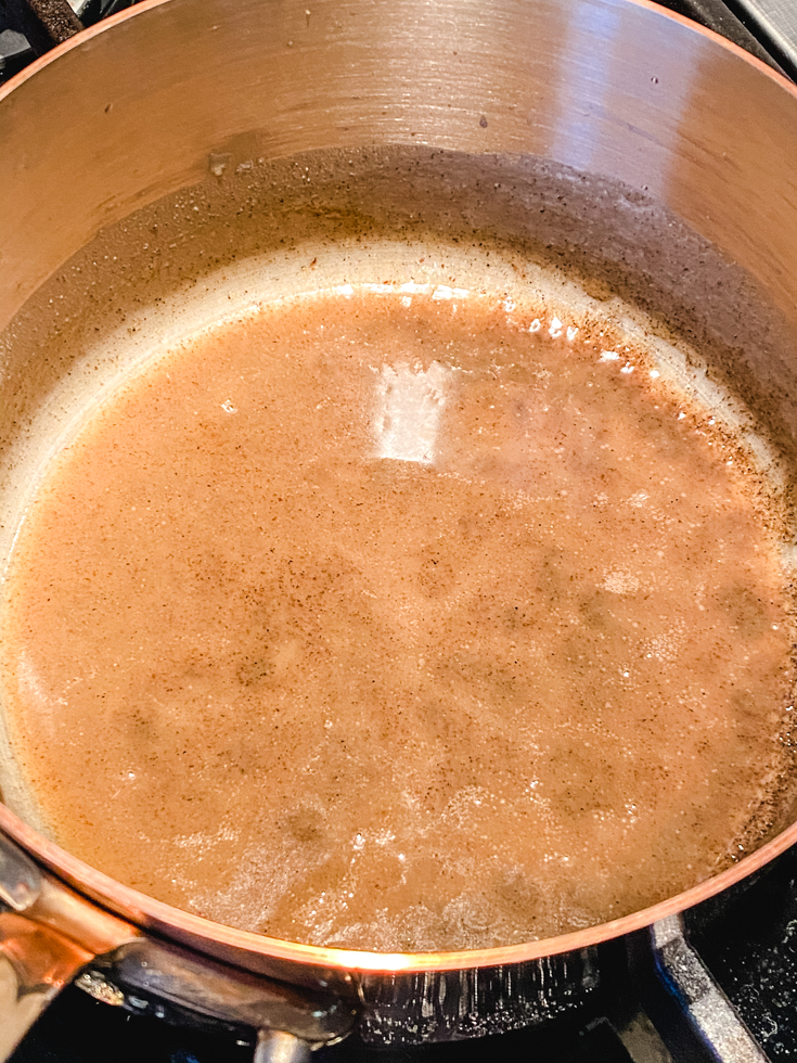 coconut milk and jaggery caramel in a saucepan