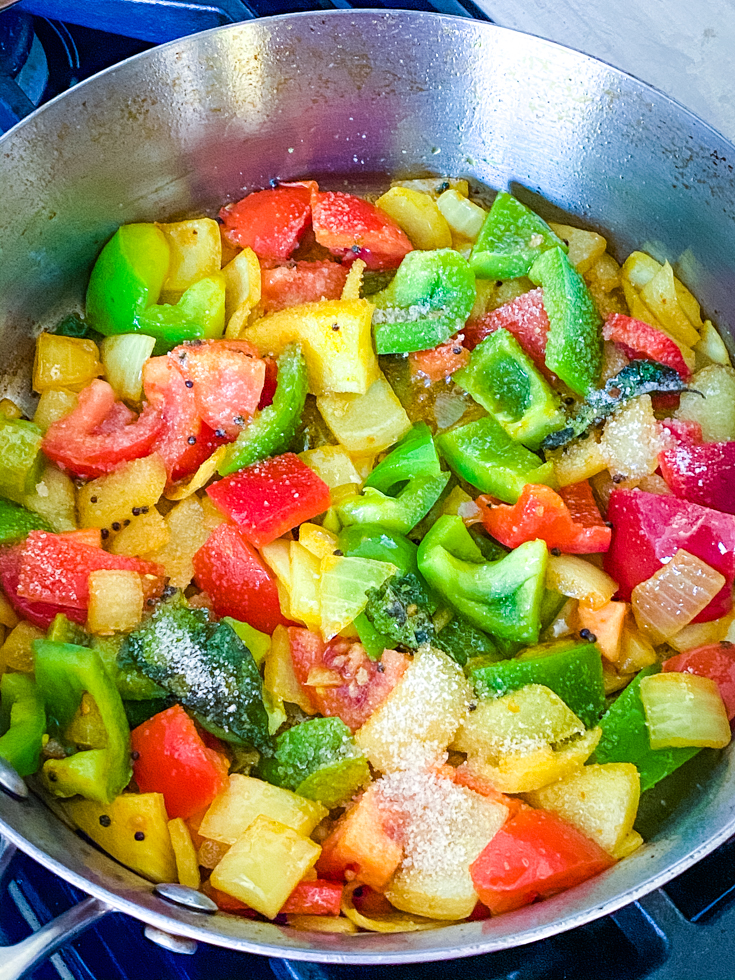 bell peppers and onions in a saute pan