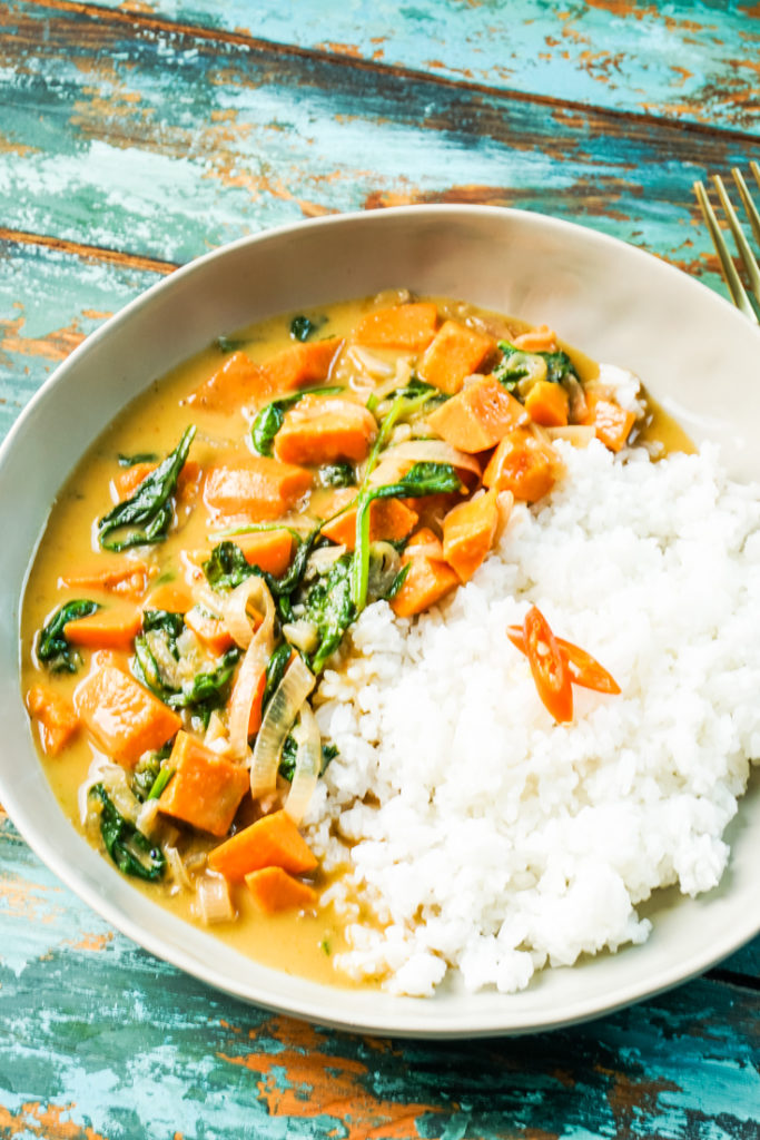 Thai sweet potato curry and white rice in a bowl