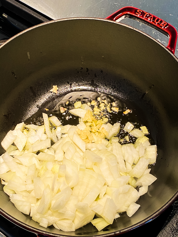 garlic and onions sweating in a Dutch oven