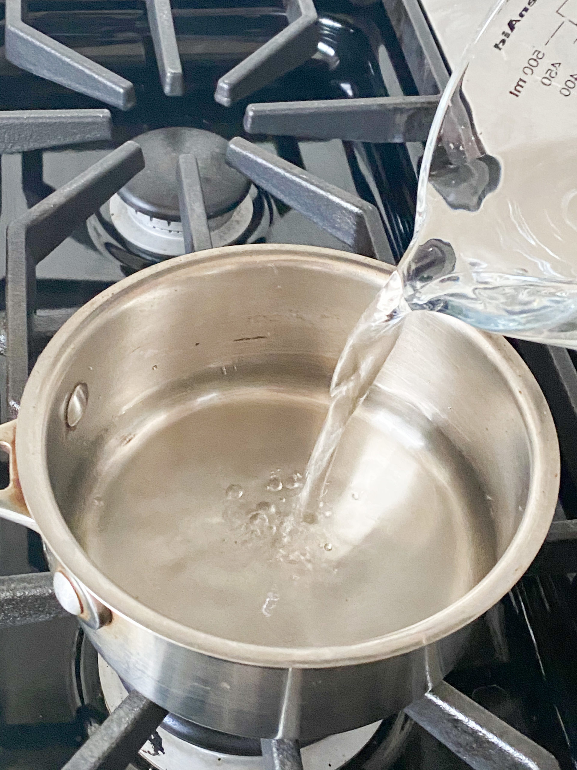 water being added to a sauce pan