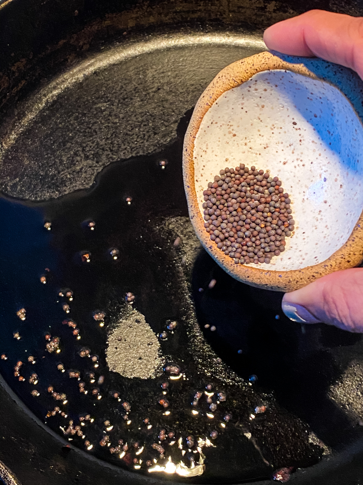 mustard seeds added to skillet