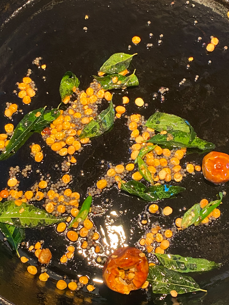 lentils and curry leaves in a skillet