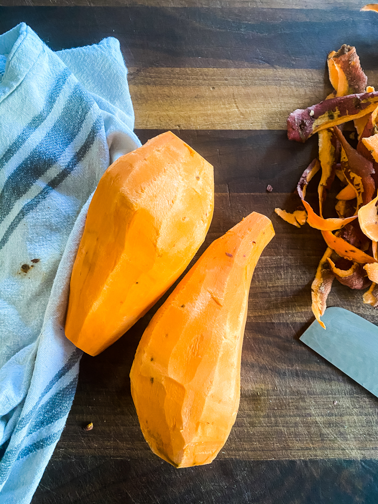 peeled sweet potatoes on a cutting board