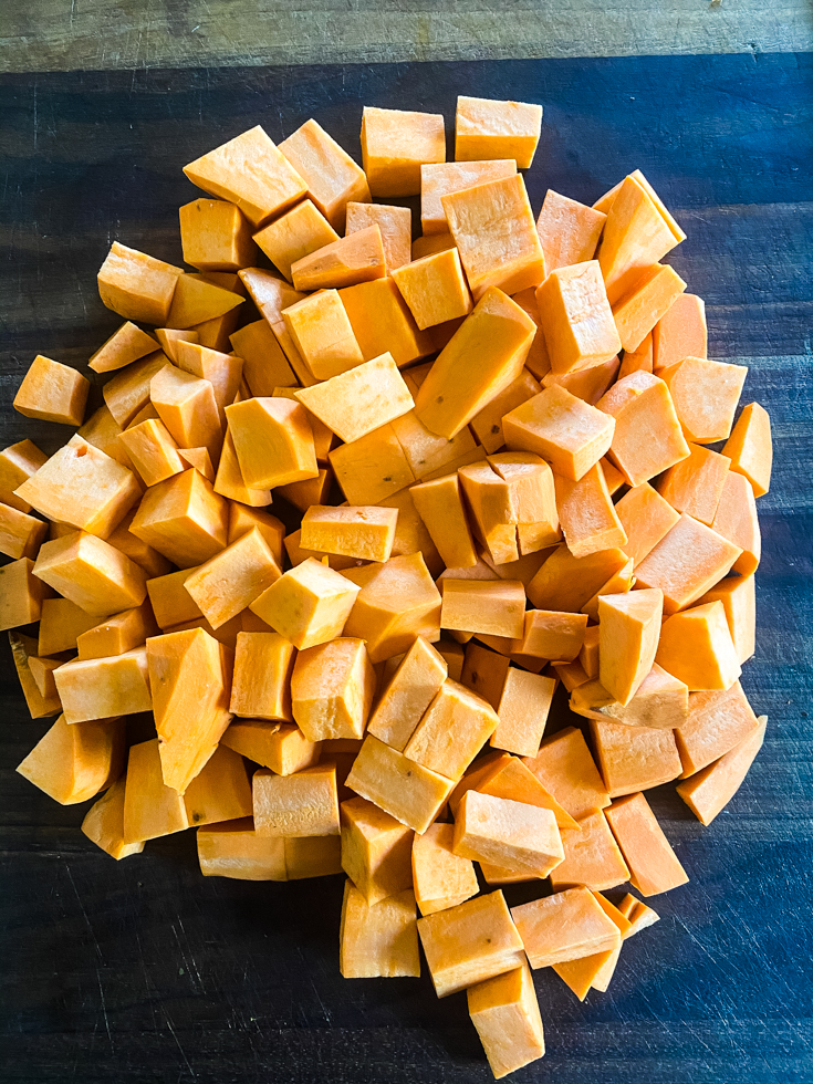 chopped sweet potatoes on a cutting board