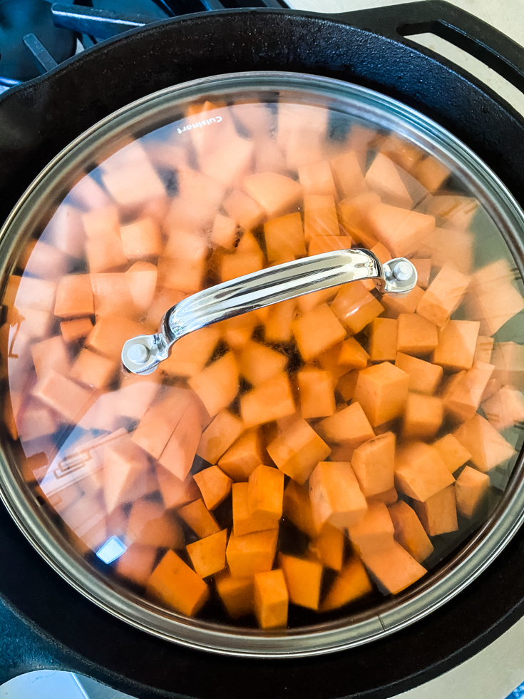 sweet potatoes covered and cooking in a skillet