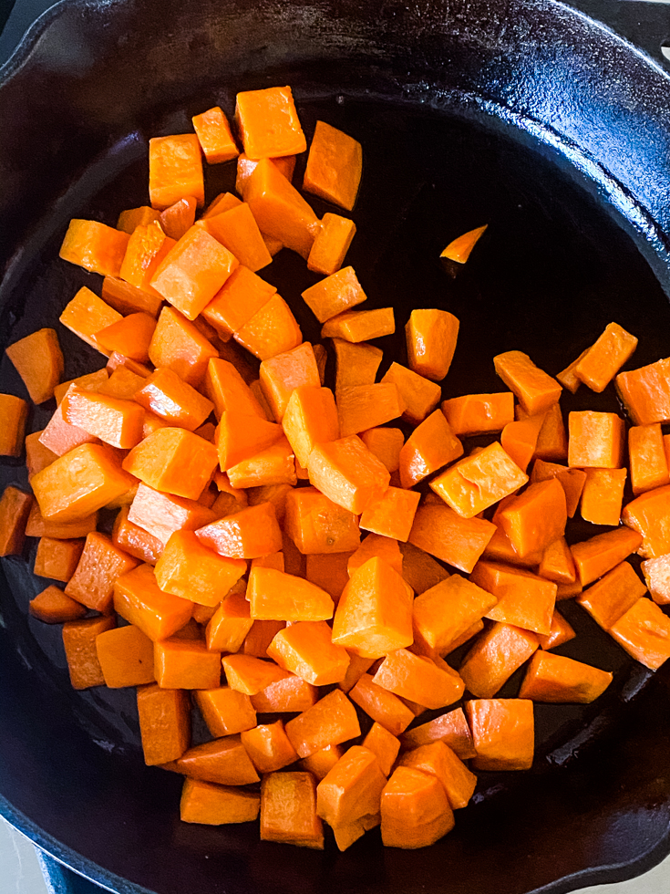 cooked sweet potatoes in a skillet