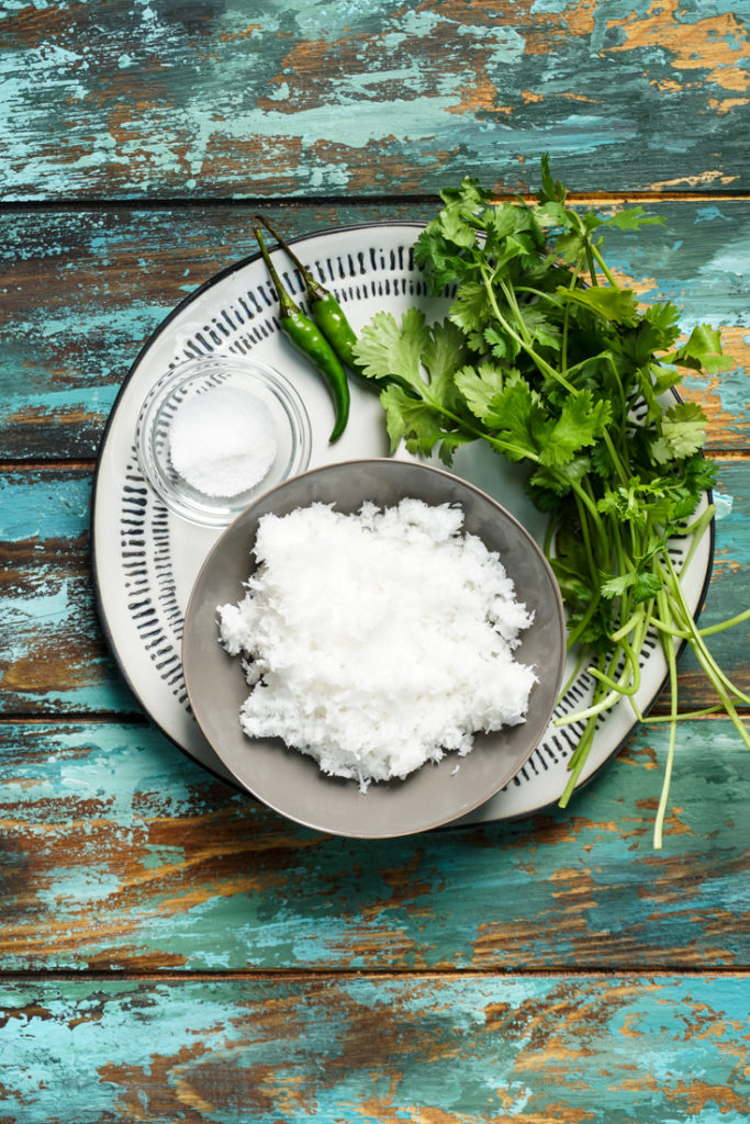 Ingredients laid out for cilantro coconut chutney on a plate