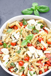 caprese pasta salad in a white bowl