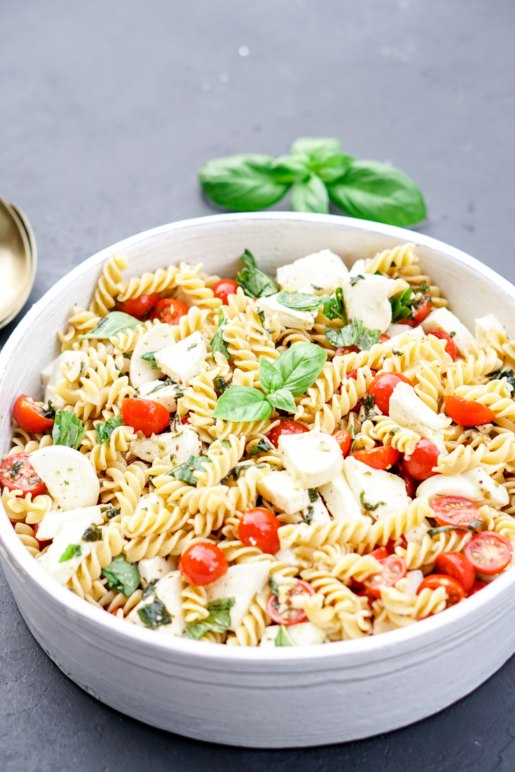 caprese pasta salad in a white bowl