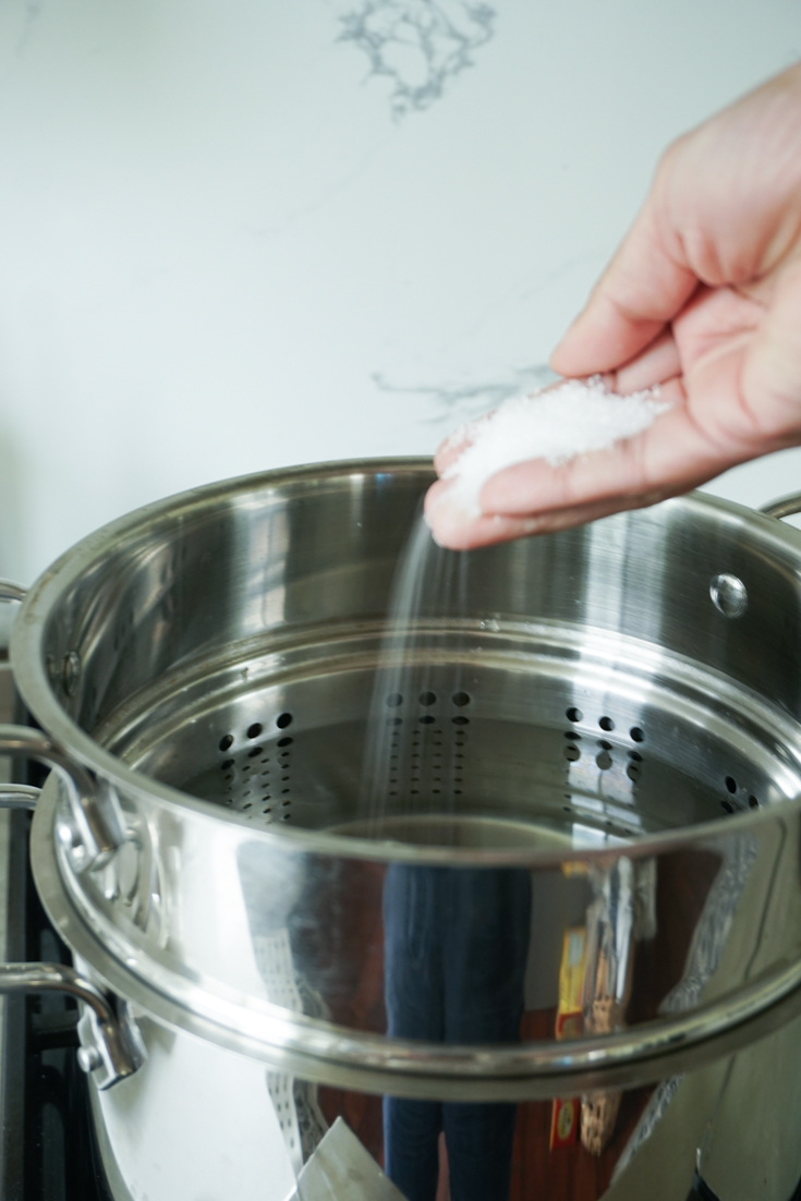 salt added to a pot of water