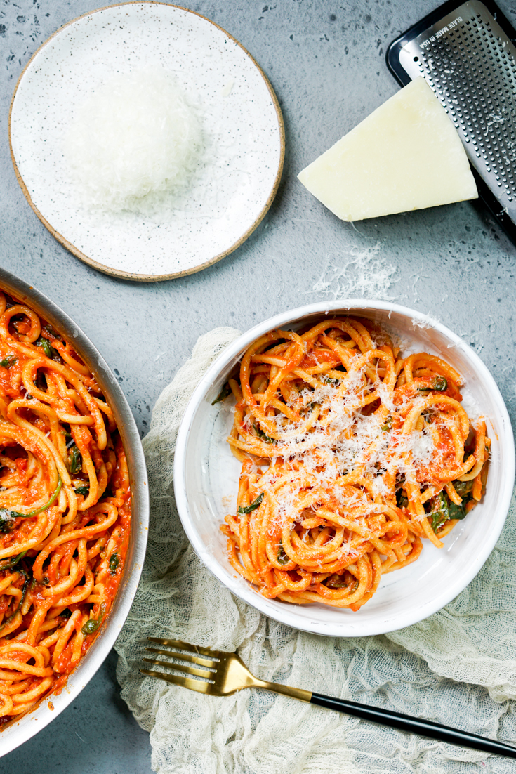 plated bowl of spaghetti with grated cheese on it