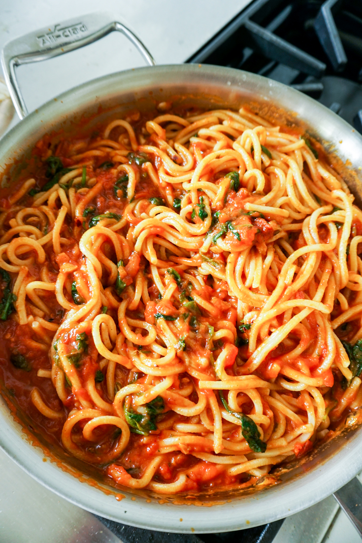 spaghetti with marinara sauce in a pan